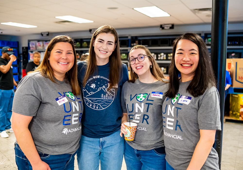 group of smiling advancial employees volunteering