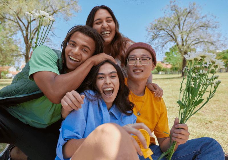 teenagers laughing and walking outisde on a bright day
