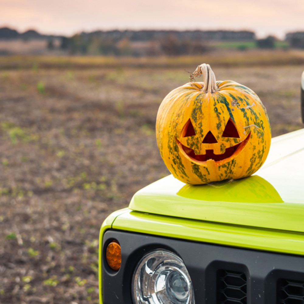 Jackolantern on a bright green Jeep