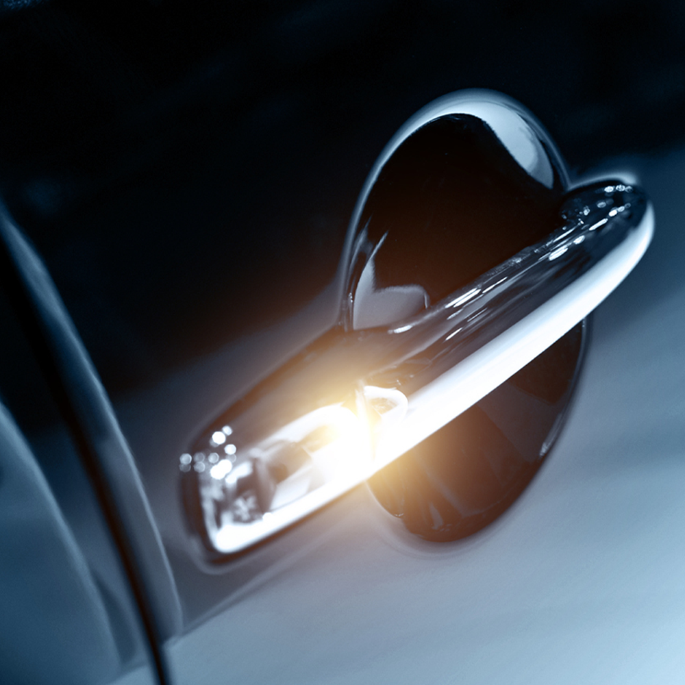 two new cars driving on a road between mountains