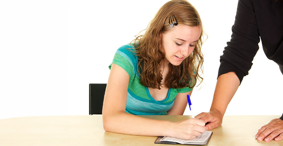 teenage girl learning how to write a check