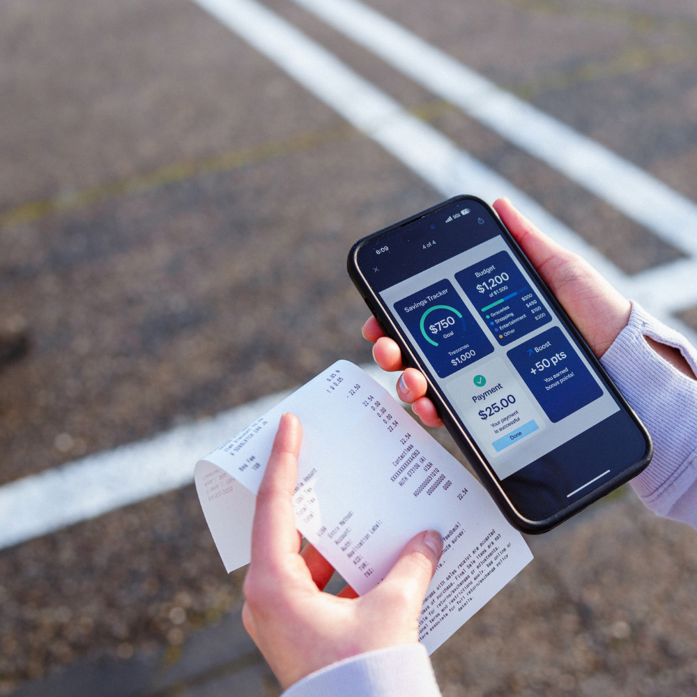 person comparing their receipt with their mobile budgeting app