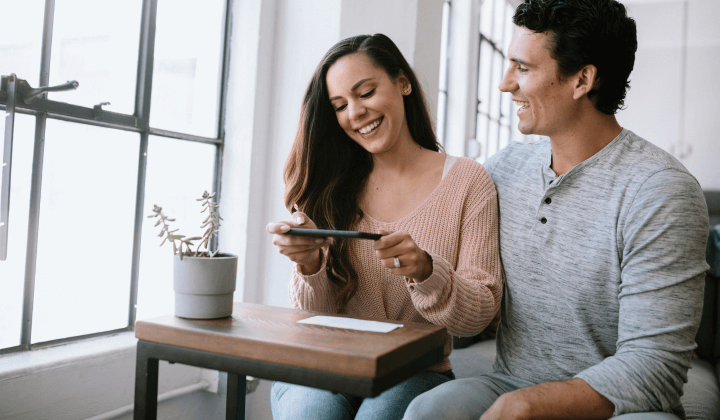 happy couple making a mobile deposit