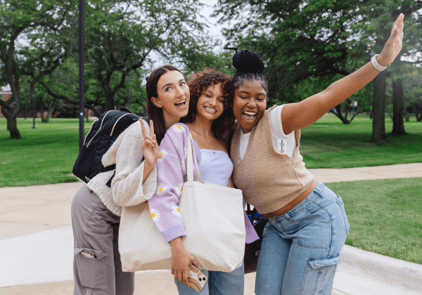 a group of teens hanging out outside on a sunny day