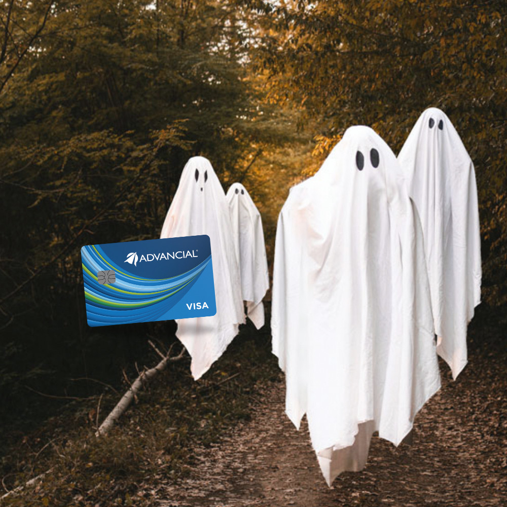A group of ghosts floating by a Visa Rewards Plus credit card