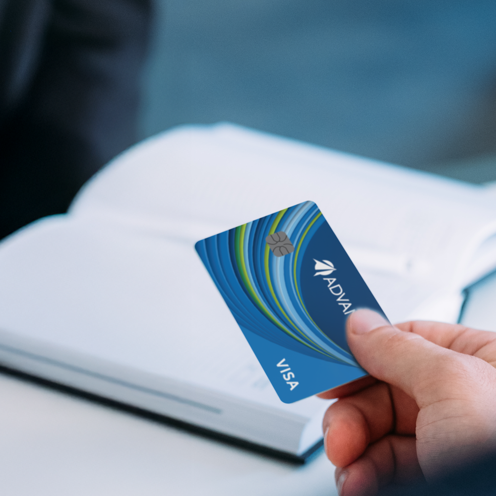 man on his laptop in the living room next to his dog