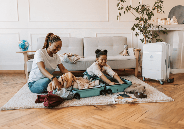 a man and woman smiling holding a Visa Rewards Plus credit card